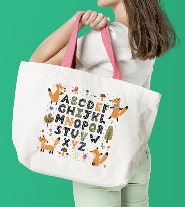 Tote bag with a fox alphabet cross stitch design showing cute woodland‑inspired letters in bright orange tones.