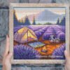 Framed cross stitch of a colorful lavender field camping landscape with mountains and sunset sky
