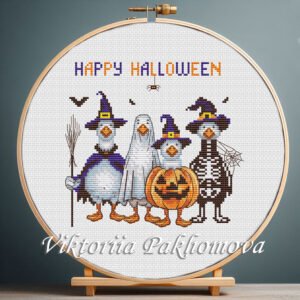 Halloween geese cross stitch displayed in a wooden hoop with spooky colorful details