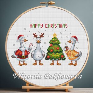 Christmas geese cross stitch displayed in a wooden hoop with festive winter details