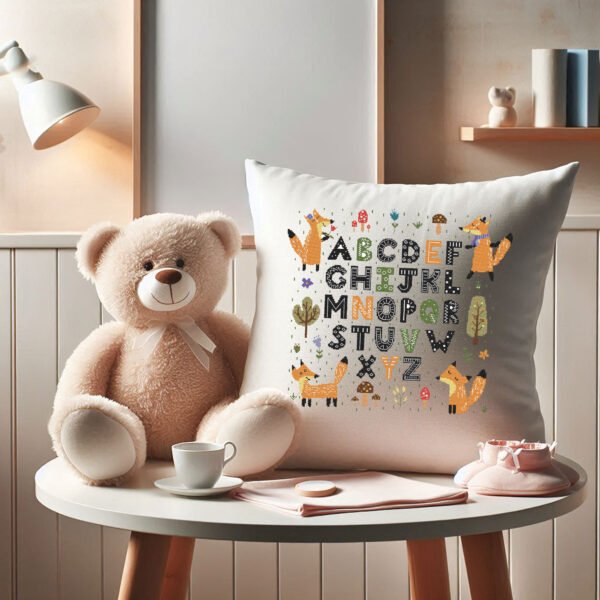 Nursery pillow featuring a fox‑themed alphabet cross stitch design with bright woodland‑style letters
