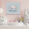 Framed cross stitch of an elephant and bunnies in a paper boat, designed for baby nursery décor