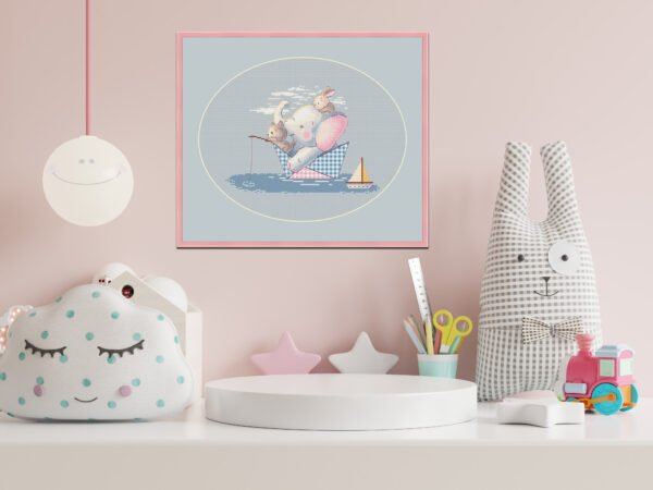 Framed cross stitch of an elephant and bunnies in a paper boat, designed for baby nursery décor