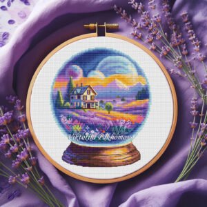 Cross stitch embroidery of a lavender glass ball scene with a house and summer colors in a wooden hoop