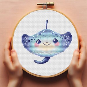 Cute baby devilfish cross stitch pattern in pastel ocean colors inside embroidery hoop
