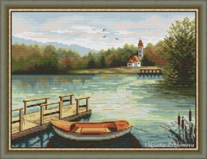Summer lake cross stitch pattern in a wooden frame with a pier, a small boat, and calm nature colors.