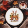 14 Autumn bunny cross stitch pattern in embroidery hoop with cozy scarf and fall leaves