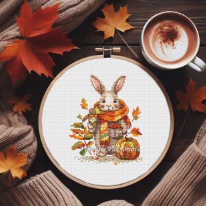 Autumn bunny cross stitch pattern in embroidery hoop with cozy scarf and fall leaves