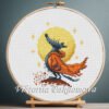 Wolf and moon cross stitch pattern in hoop – whimsical woodland embroidery with orange cloak and glowing moon